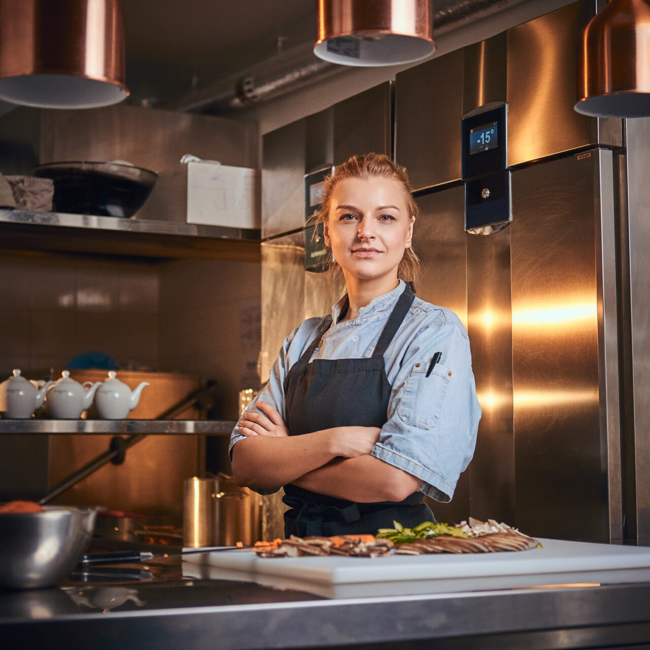 Confident,And,Serious,Female,Chef,Standing,With,Hands,Crossed,In